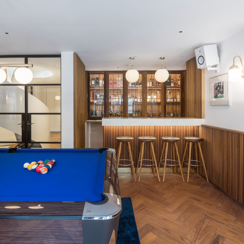 Home bar - transitional medium tone wood floor and brown floor home bar idea in London
