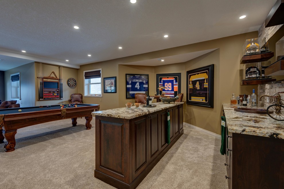 This is an example of a large classic walk-out basement in Toronto with carpet, a standard fireplace and a stone fireplace surround.