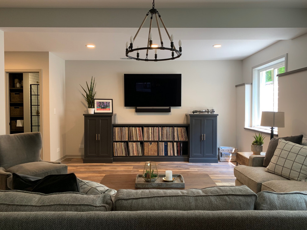 Mid-sized mountain style look-out vinyl floor and brown floor basement photo in Chicago with beige walls, a standard fireplace and a wood fireplace surround