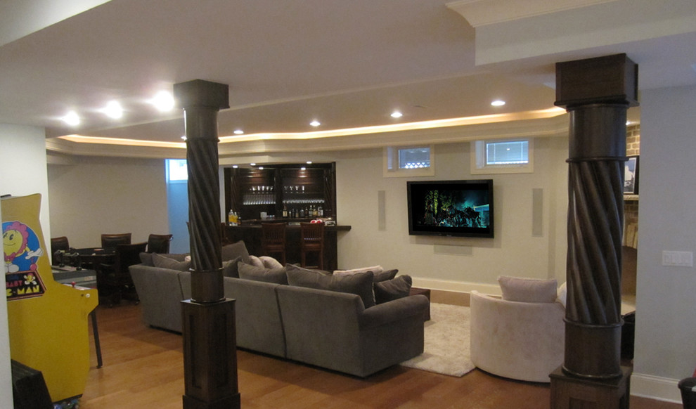 Photo of a large classic look-out basement in Chicago with white walls and light hardwood flooring.