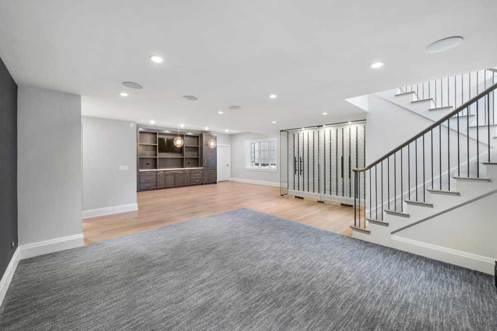 Example of a large transitional look-out light wood floor basement design in Chicago with gray walls