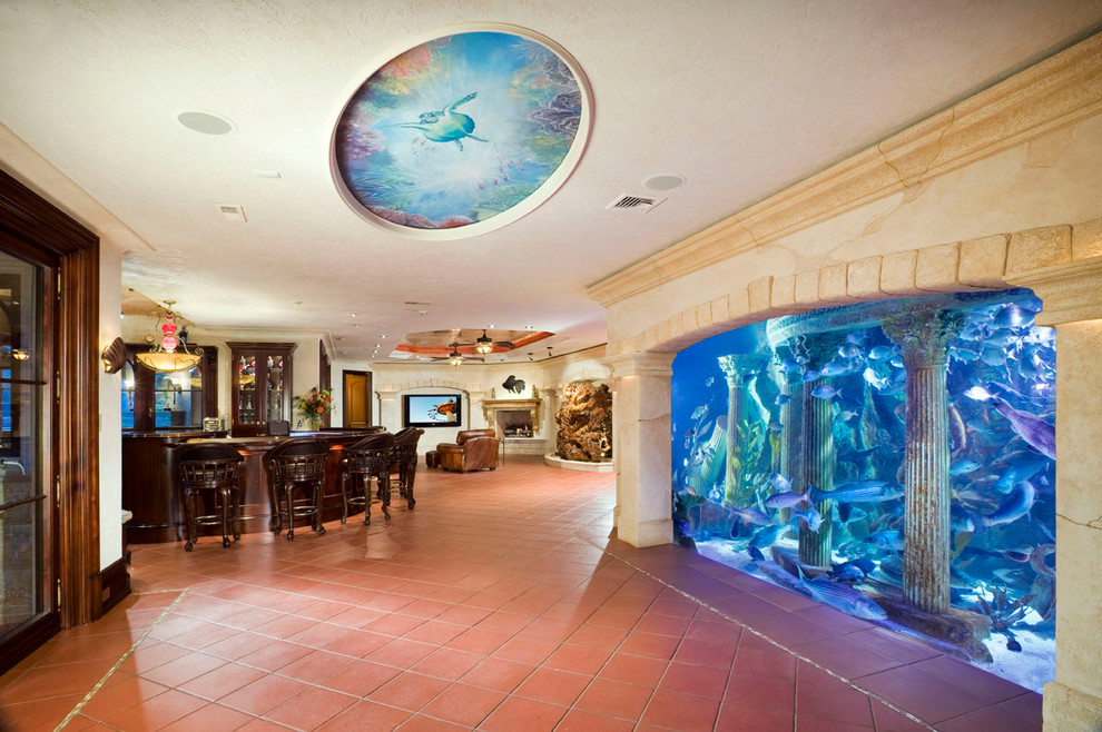 Tuscan underground terra-cotta tile and red floor basement photo in New York with beige walls and a standard fireplace