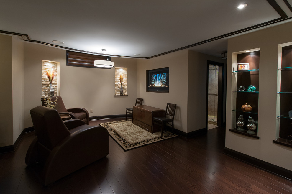 Large contemporary look-out basement in Ottawa with beige walls, dark hardwood flooring and no fireplace.