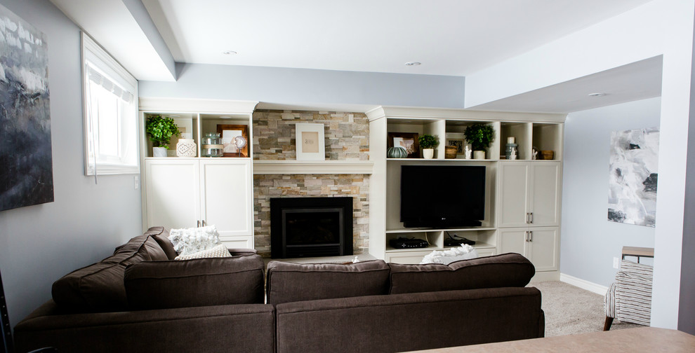 Medium sized classic look-out basement in Toronto with grey walls, carpet, a standard fireplace and a stone fireplace surround.