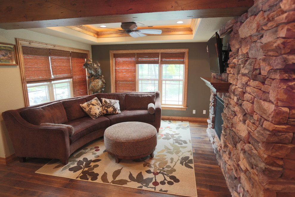 Example of a mid-sized mountain style dark wood floor basement design in Milwaukee with brown walls