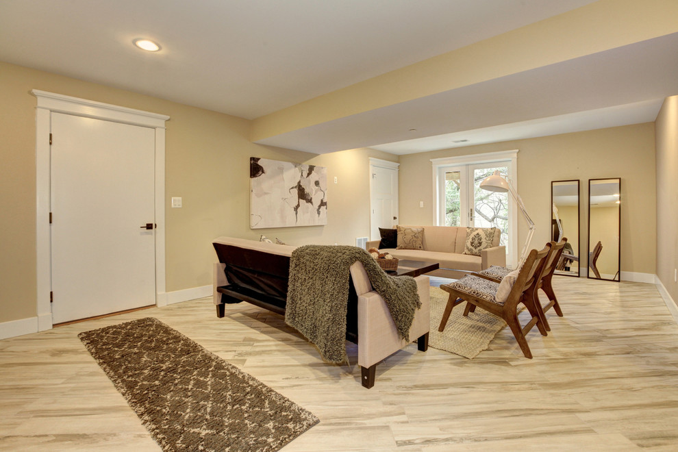 This is an example of an expansive traditional walk-out basement in DC Metro with beige walls and ceramic flooring.