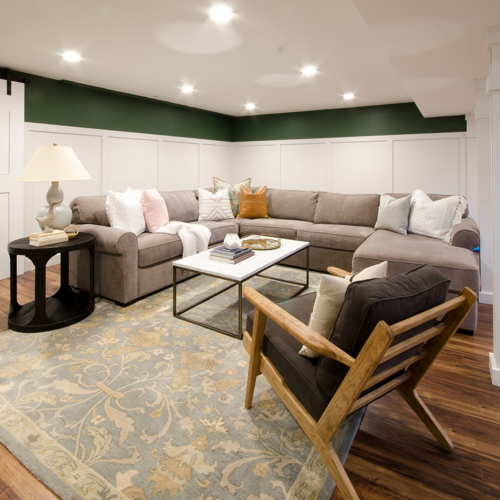 Example of a large light wood floor and brown floor basement design in New York with green walls