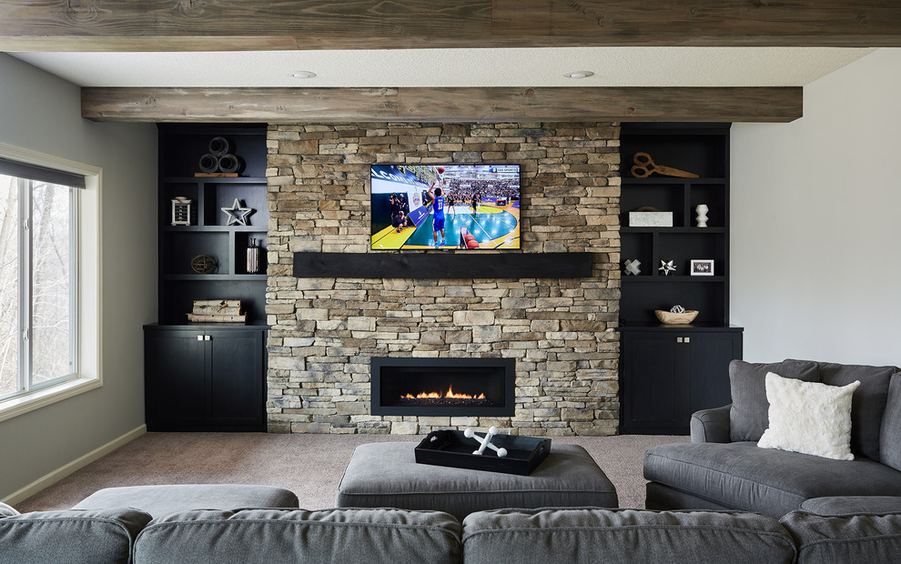 Design ideas for a medium sized industrial walk-out basement in Minneapolis with grey walls, carpet, a standard fireplace, a stone fireplace surround and beige floors.