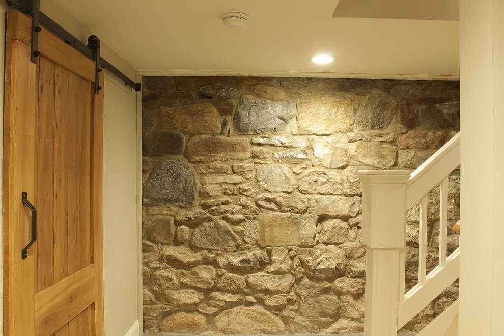 This is an example of a large traditional look-out basement in New York with beige walls, no fireplace, porcelain flooring and grey floors.