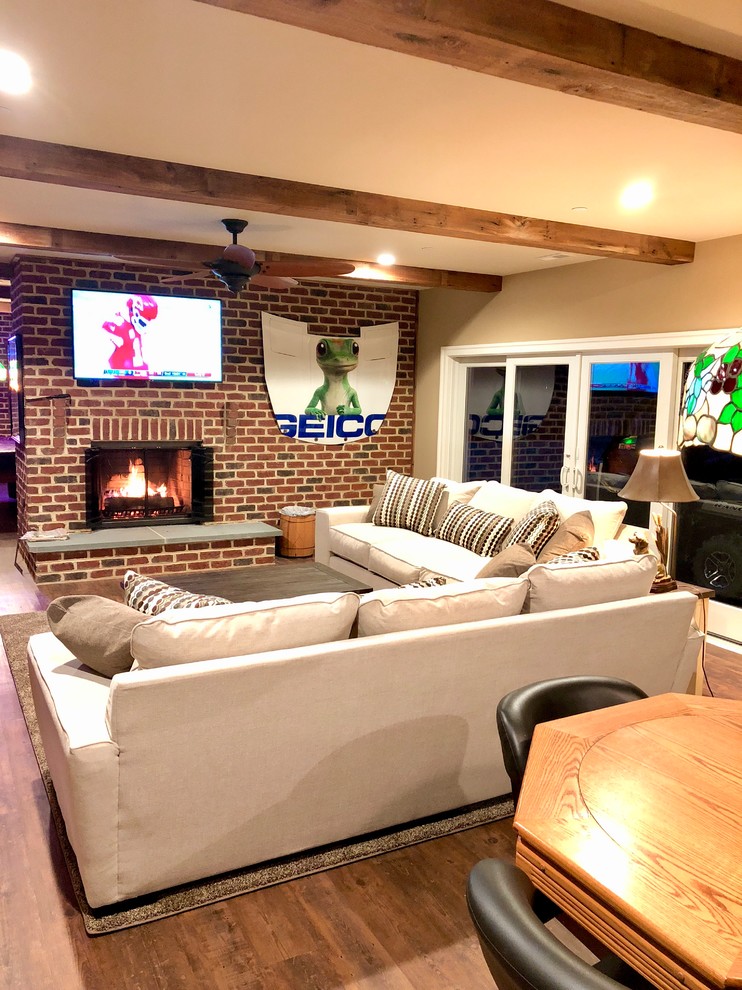 Large walk-out vinyl floor and brown floor basement photo in Baltimore with a standard fireplace and a brick fireplace