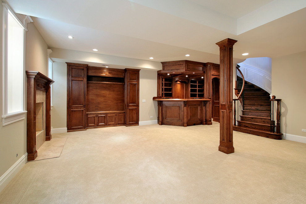This is an example of a large modern look-out basement in Detroit with beige walls, carpet, a standard fireplace and a stone fireplace surround.