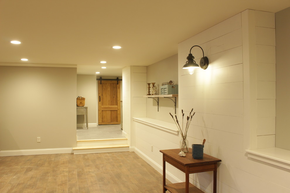 Basement - large cottage look-out laminate floor and brown floor basement idea in New York with beige walls and no fireplace