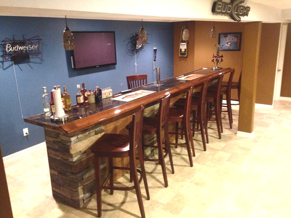 This is an example of a large classic walk-out basement in Cincinnati with blue walls.