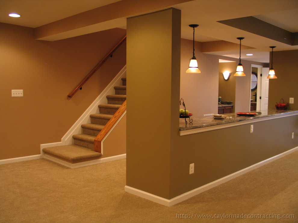 Example of a large trendy walk-out carpeted basement design in Baltimore with no fireplace and brown walls
