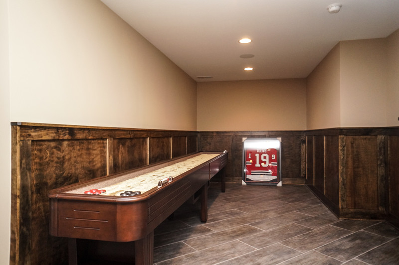 Design ideas for a large rustic walk-out basement in Chicago with beige walls.