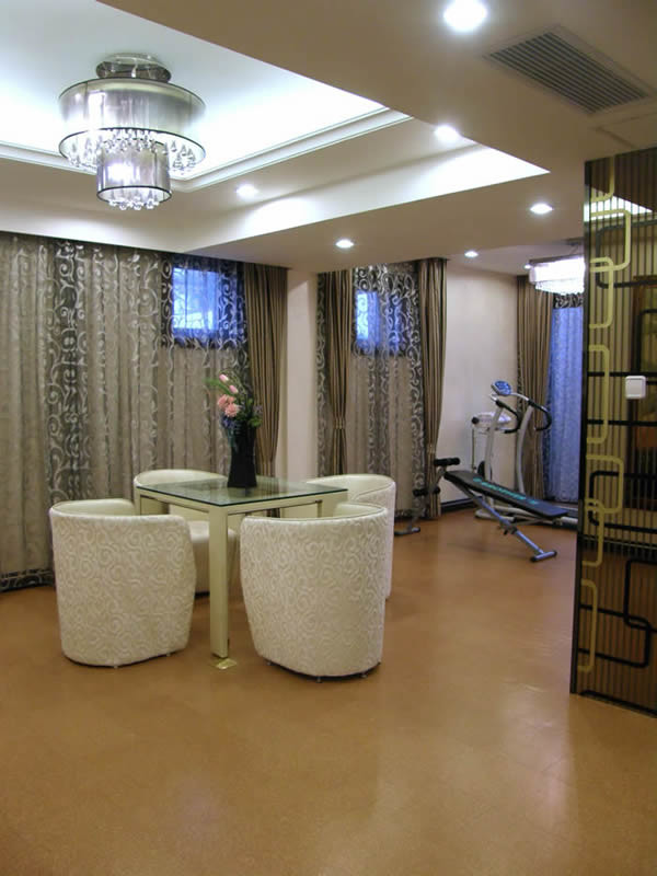 This is an example of a large modern basement in Orlando with white walls, cork flooring and brown floors.