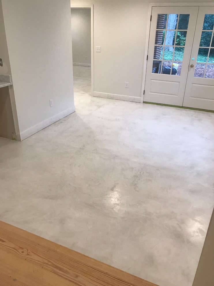 Design ideas for a basement in Atlanta with concrete flooring and white floors.