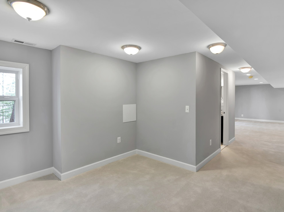 Idée de décoration pour un grand sous-sol minimaliste donnant sur l'extérieur avec un mur gris, moquette et un sol blanc.