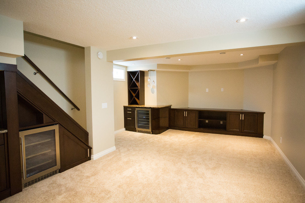 Inspiration for a mid-sized contemporary underground carpeted basement remodel in Calgary with beige walls