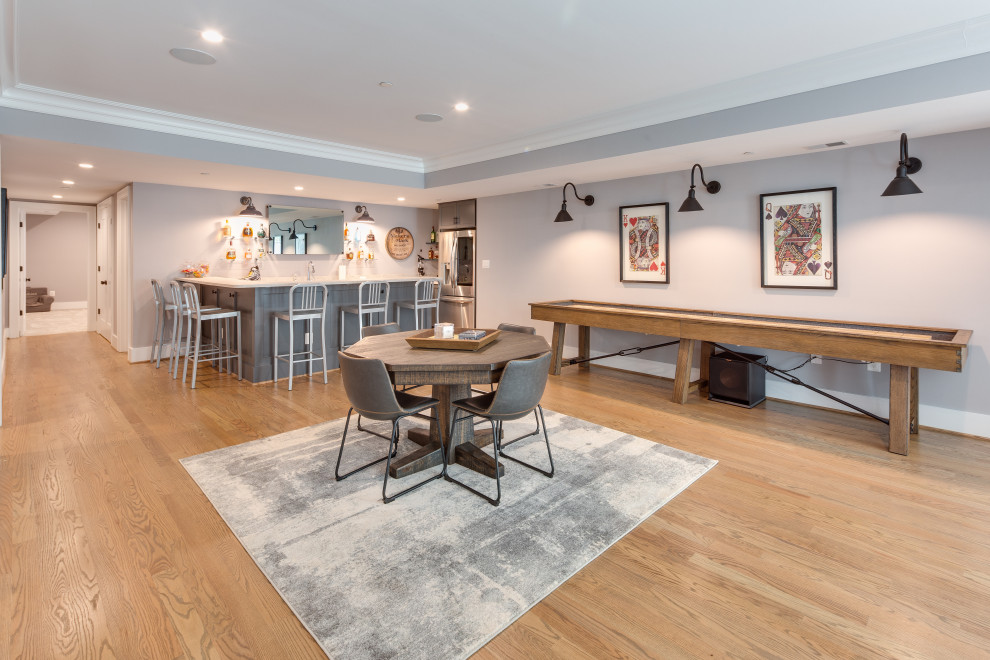 Large traditional walk-out basement in DC Metro with a home bar, grey walls, medium hardwood flooring and a coffered ceiling.