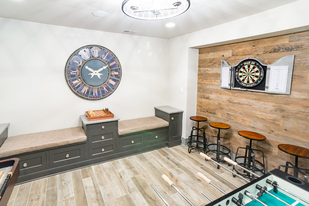 Example of a huge mountain style underground laminate floor and gray floor basement design in Philadelphia with multicolored walls