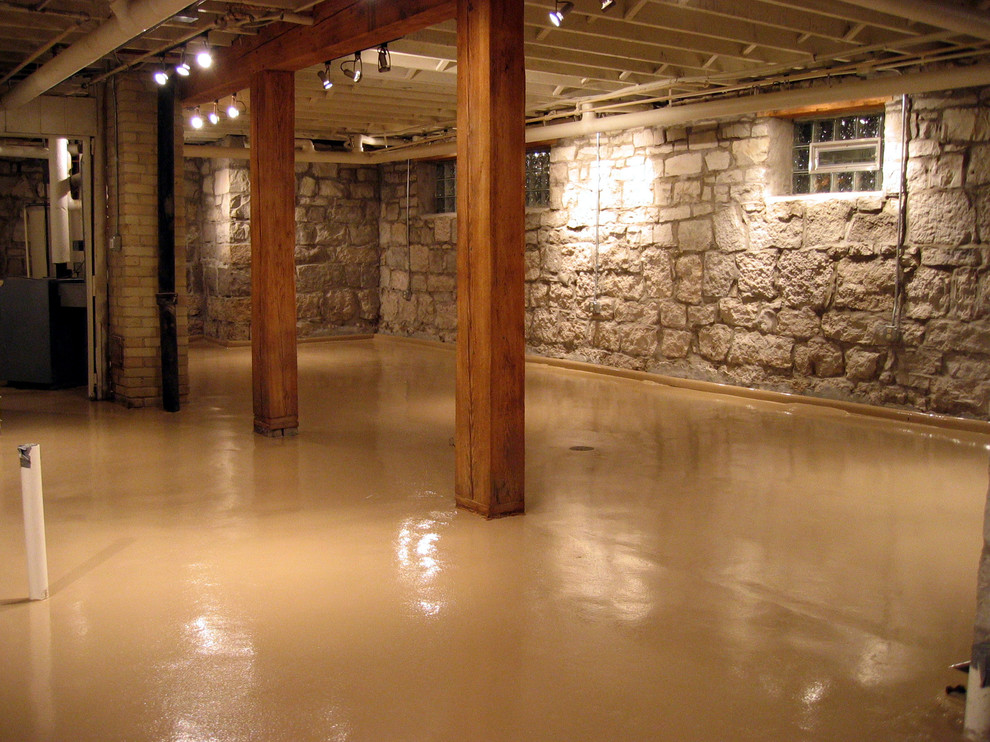 Basement - mid-sized rustic look-out concrete floor and brown floor basement idea with no fireplace and multicolored walls