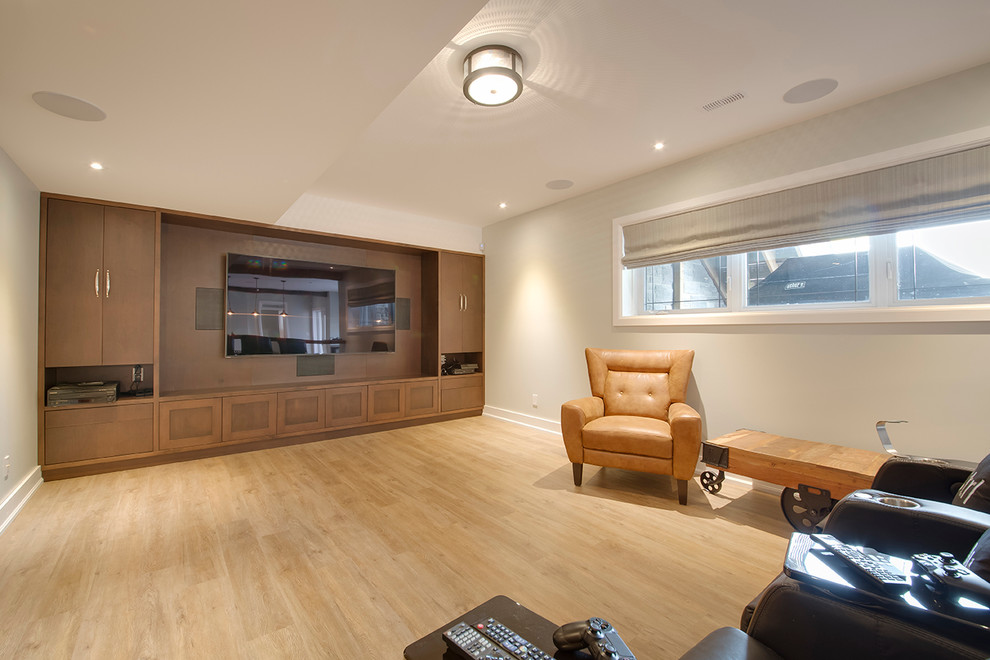 Photo of a medium sized country look-out basement in Toronto with beige walls, light hardwood flooring, no fireplace and brown floors.