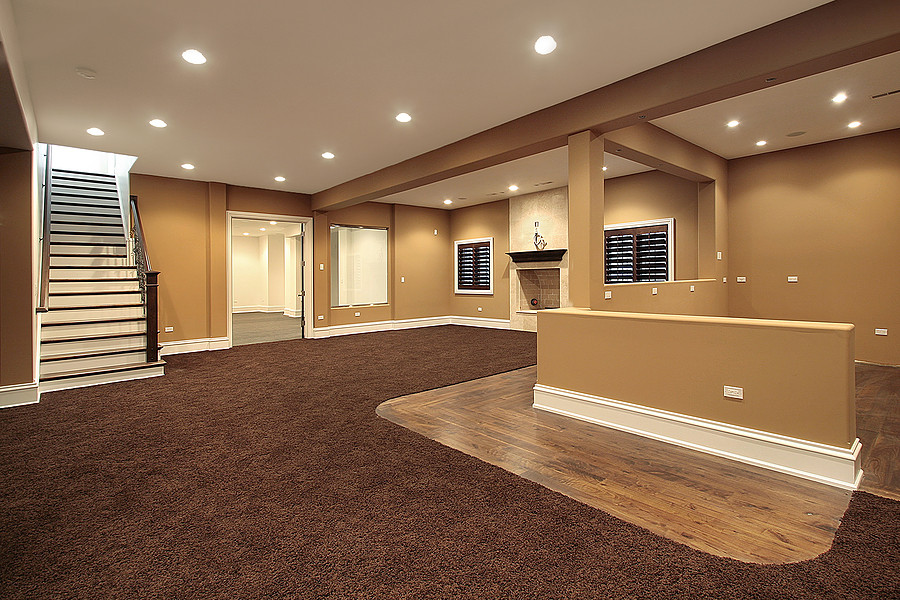 Basement - mid-sized traditional underground carpeted and brown floor basement idea in New York with beige walls, a standard fireplace and a stone fireplace