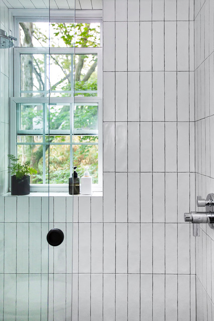 Glass-enclosed shower with vertically-stacked subway tile - Modern