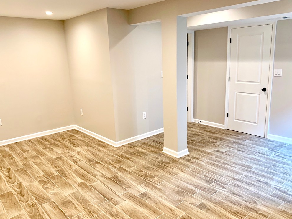 Mid-sized elegant walk-out porcelain tile and beige floor basement photo in DC Metro with gray walls