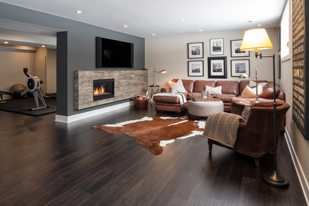 Example of a minimalist dark wood floor basement design in Ottawa with a stone fireplace