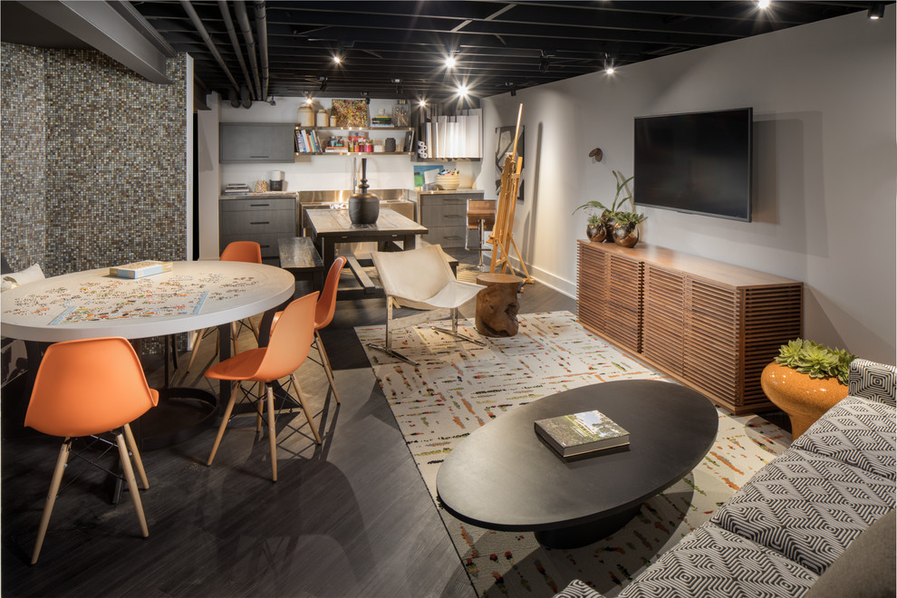 Example of a large transitional walk-out dark wood floor and black floor basement design in Indianapolis with gray walls