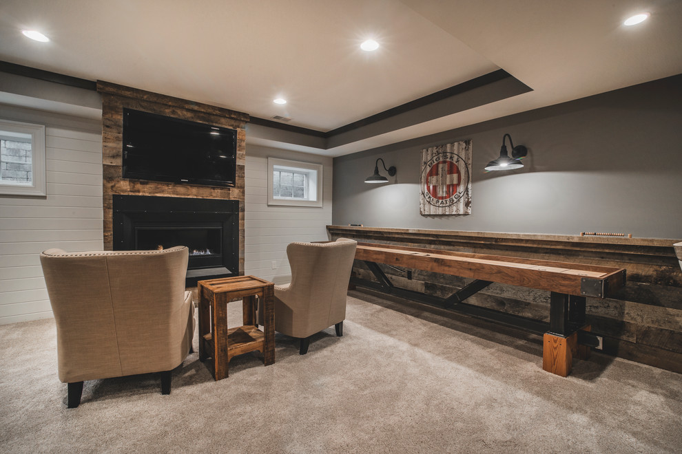 Inspiration for a large rustic look-out carpeted basement remodel in Columbus with gray walls, a ribbon fireplace and a metal fireplace