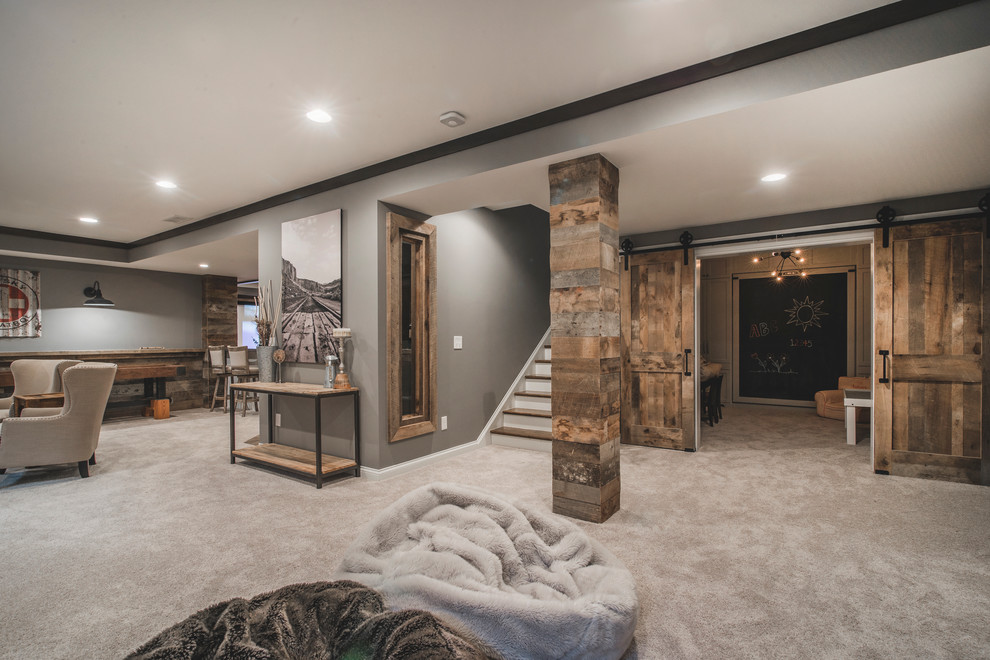 Example of a large mountain style look-out carpeted and gray floor basement design in Columbus with gray walls