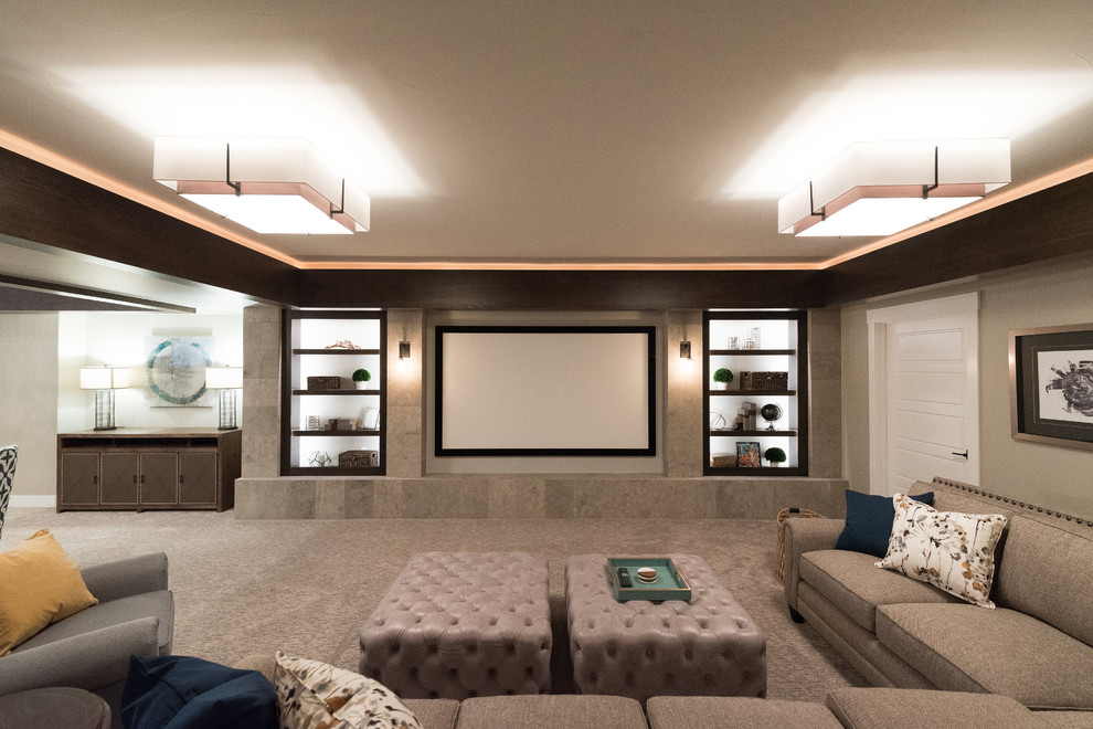 Inspiration for a large traditional home cinema in Denver with beige walls, carpet and brown floors.