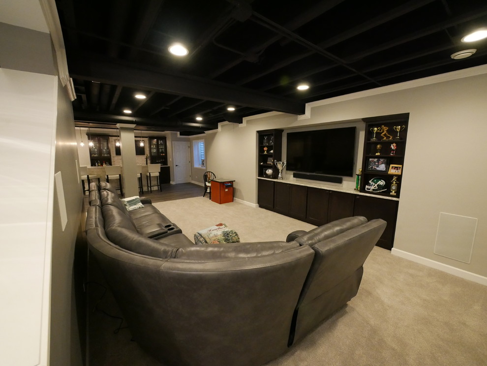 Inspiration for a large contemporary look-out carpeted and beige floor basement remodel in Chicago with gray walls and no fireplace
