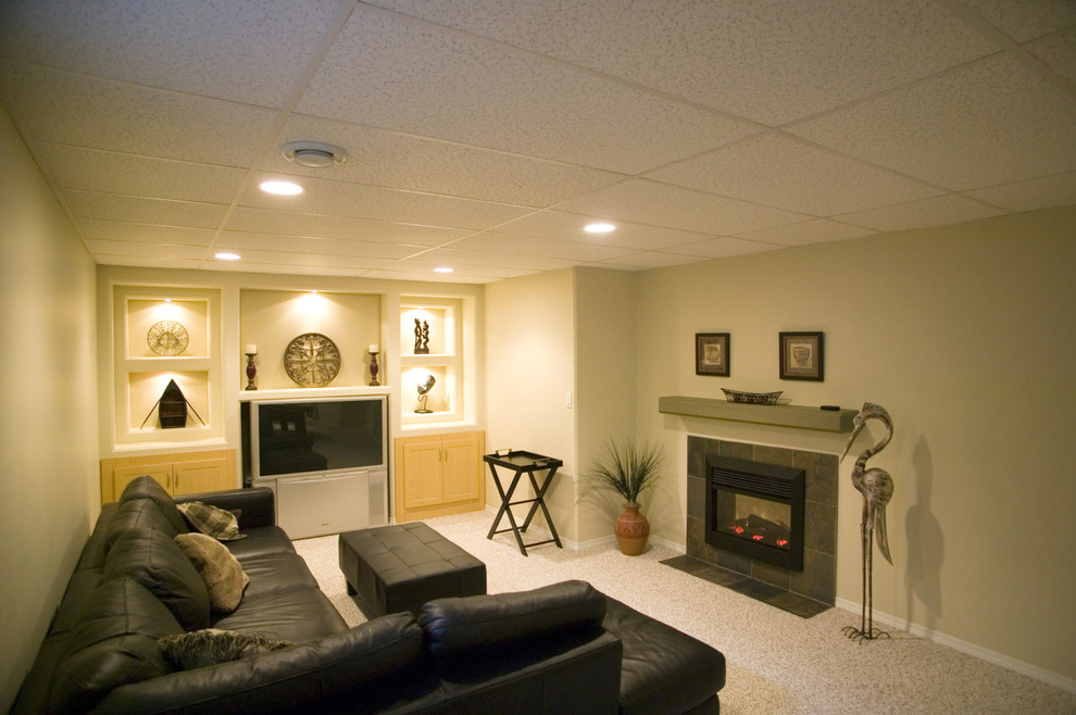 Example of a large trendy underground carpeted basement design in Other with green walls, a standard fireplace and a tile fireplace
