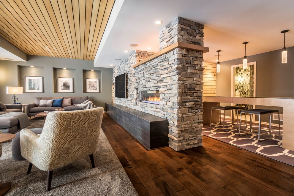 Design ideas for a contemporary basement in Minneapolis with a ribbon fireplace and a stone fireplace surround.