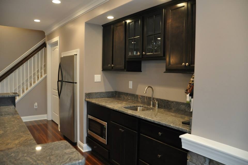 Example of a large classic walk-out dark wood floor and brown floor basement design in Philadelphia with gray walls and no fireplace