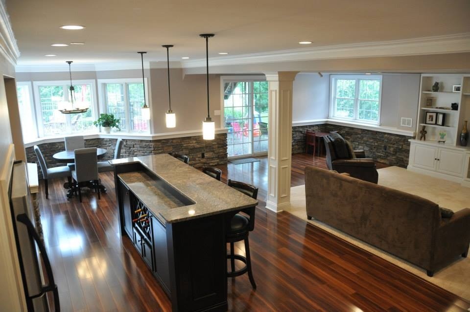 Example of a large classic walk-out dark wood floor and brown floor basement design in Philadelphia with gray walls and no fireplace