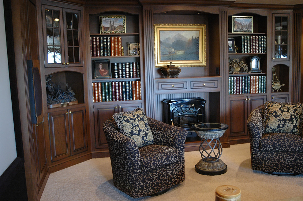 Example of a large classic walk-out carpeted and beige floor basement design in Denver with beige walls, a wood stove and a wood fireplace surround