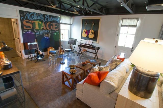 Photo of a large eclectic walk-out basement in Nashville with grey walls, concrete flooring and no fireplace.