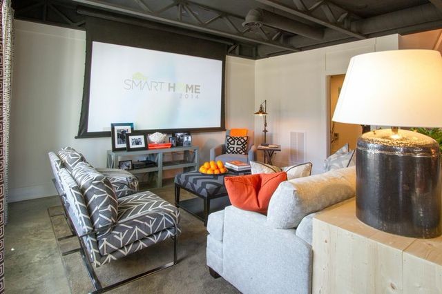Design ideas for a large eclectic walk-out basement in Nashville with grey walls, concrete flooring and no fireplace.