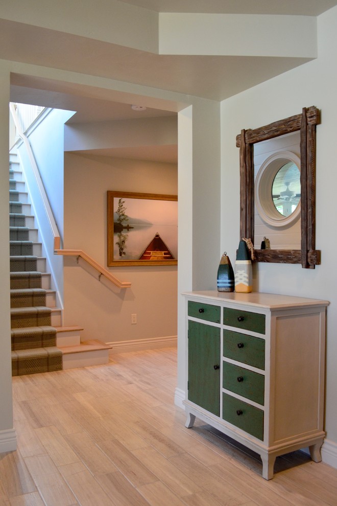 Photo of a nautical walk-out basement in Other with grey walls and a standard fireplace.