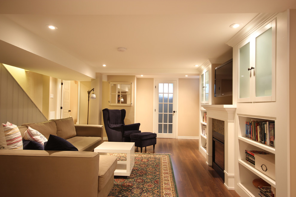 Design ideas for a classic games room in Ottawa with beige walls, dark hardwood flooring, a standard fireplace, a tiled fireplace surround and brown floors.