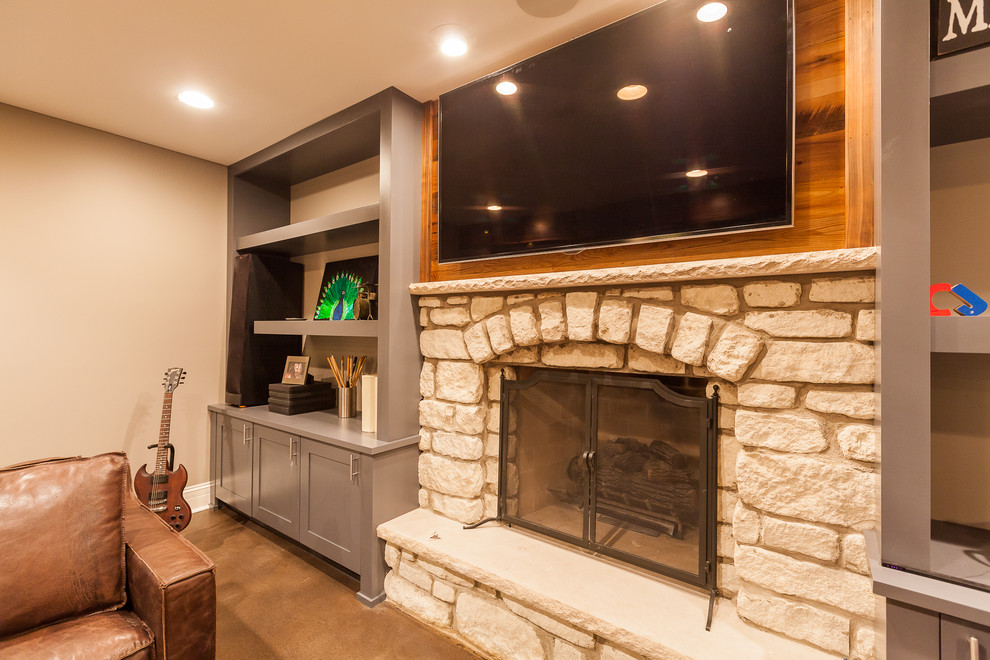 Design ideas for an expansive urban look-out basement in Chicago with beige walls, concrete flooring, a standard fireplace, a stone fireplace surround and beige floors.