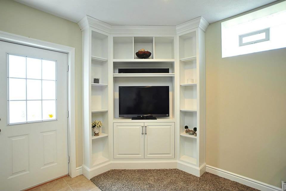 Photo of a small modern basement in Other with beige walls and carpet.