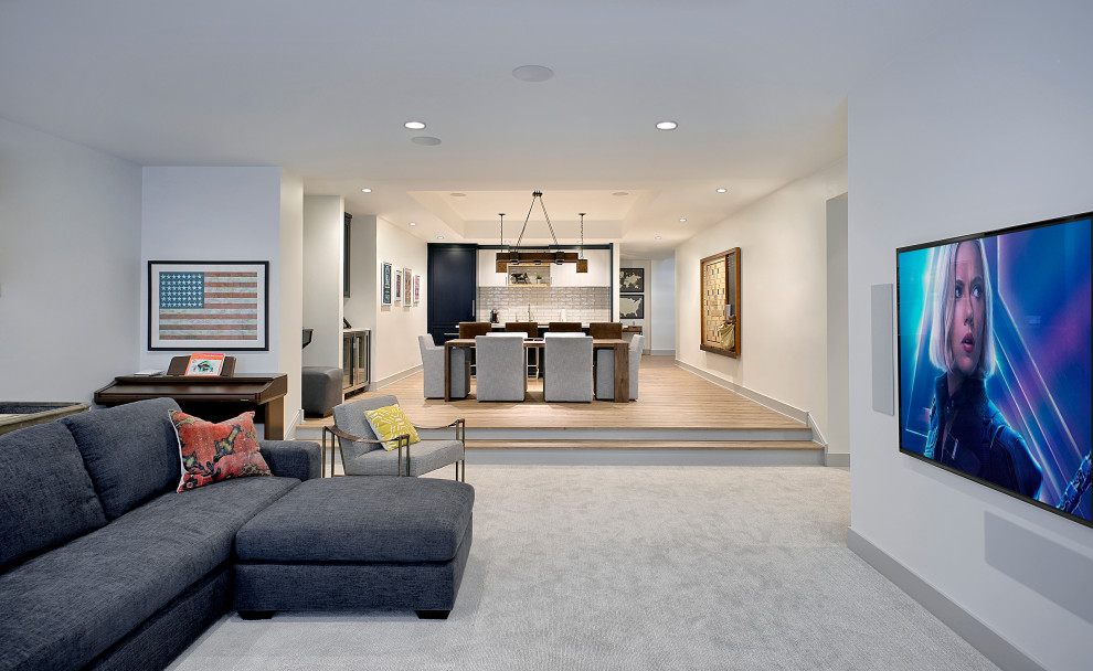 Example of a large transitional underground carpeted and gray floor basement design in Chicago with a home theater and white walls