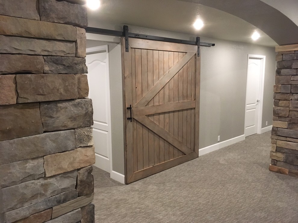 Example of a mid-sized cottage underground carpeted basement design in Denver with gray walls