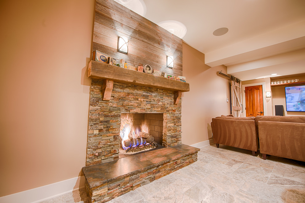 Example of a mid-sized mountain style ceramic tile basement design in Chicago with beige walls, a standard fireplace and a stone fireplace